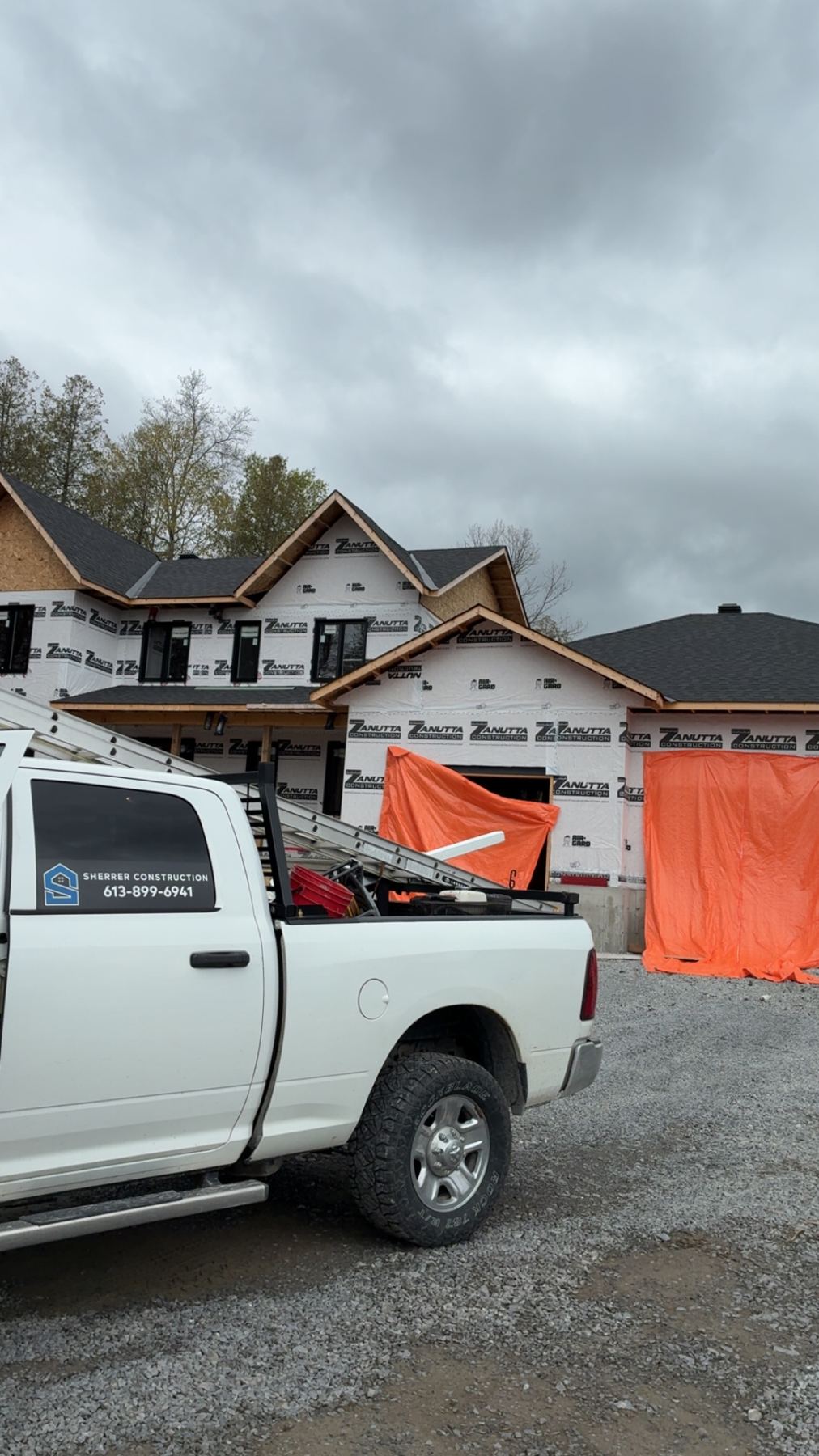 A Sherrer Construction truck at a new build in housewrap